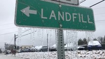 Freezing rain leaves ground literally frozen, icicles hang on signs