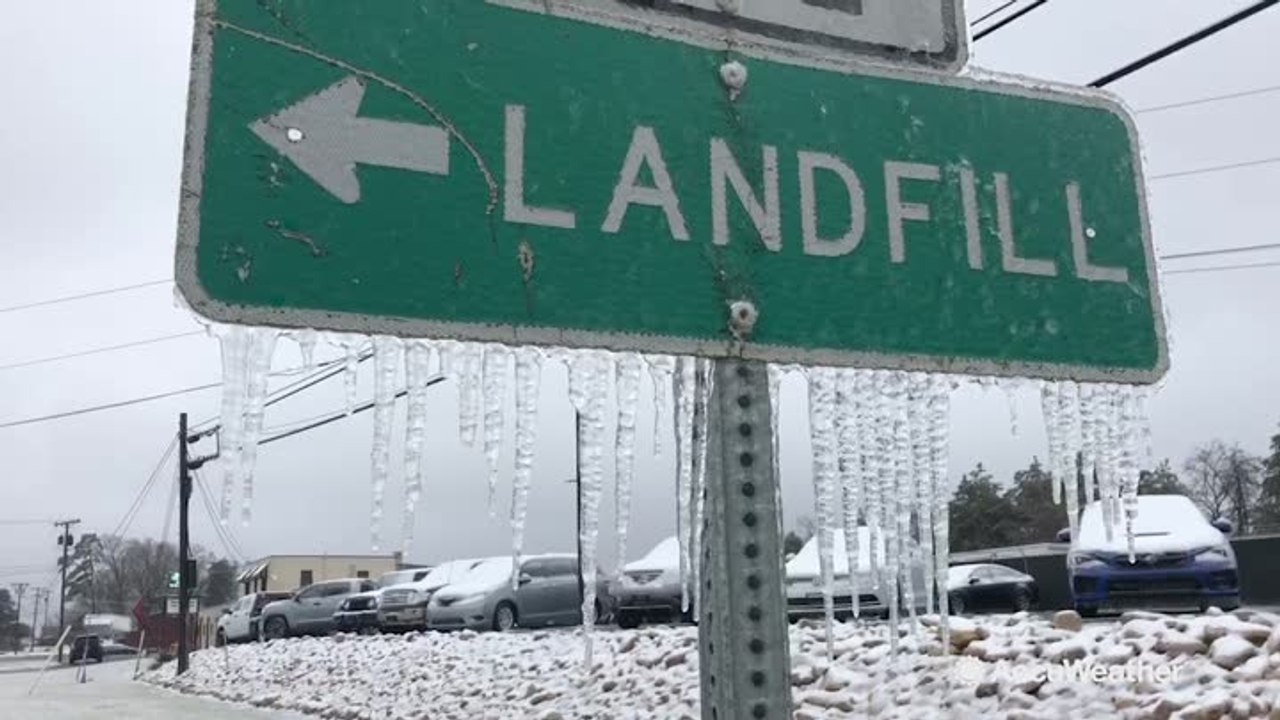 Freezing rain leaves ground literally frozen, icicles hang on signs
