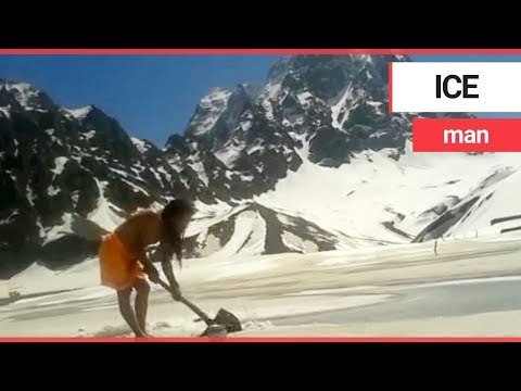Holy man digs through ice to take an outdoor bath in the Himalayan mountains | SWNS TV