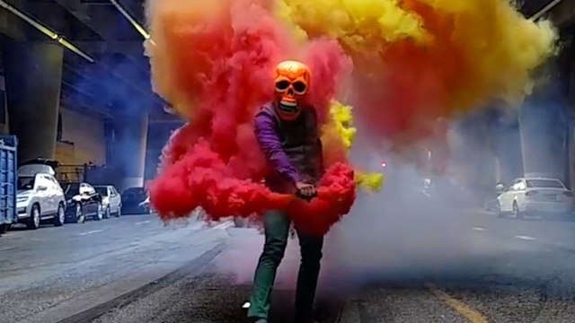 Performance Artist Uses Smoke Grenades And Skull Mask To Create Colorful Visuals