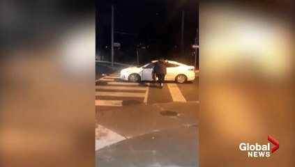 Video shows road rage incident involving man appearing to jump on hood of moving car