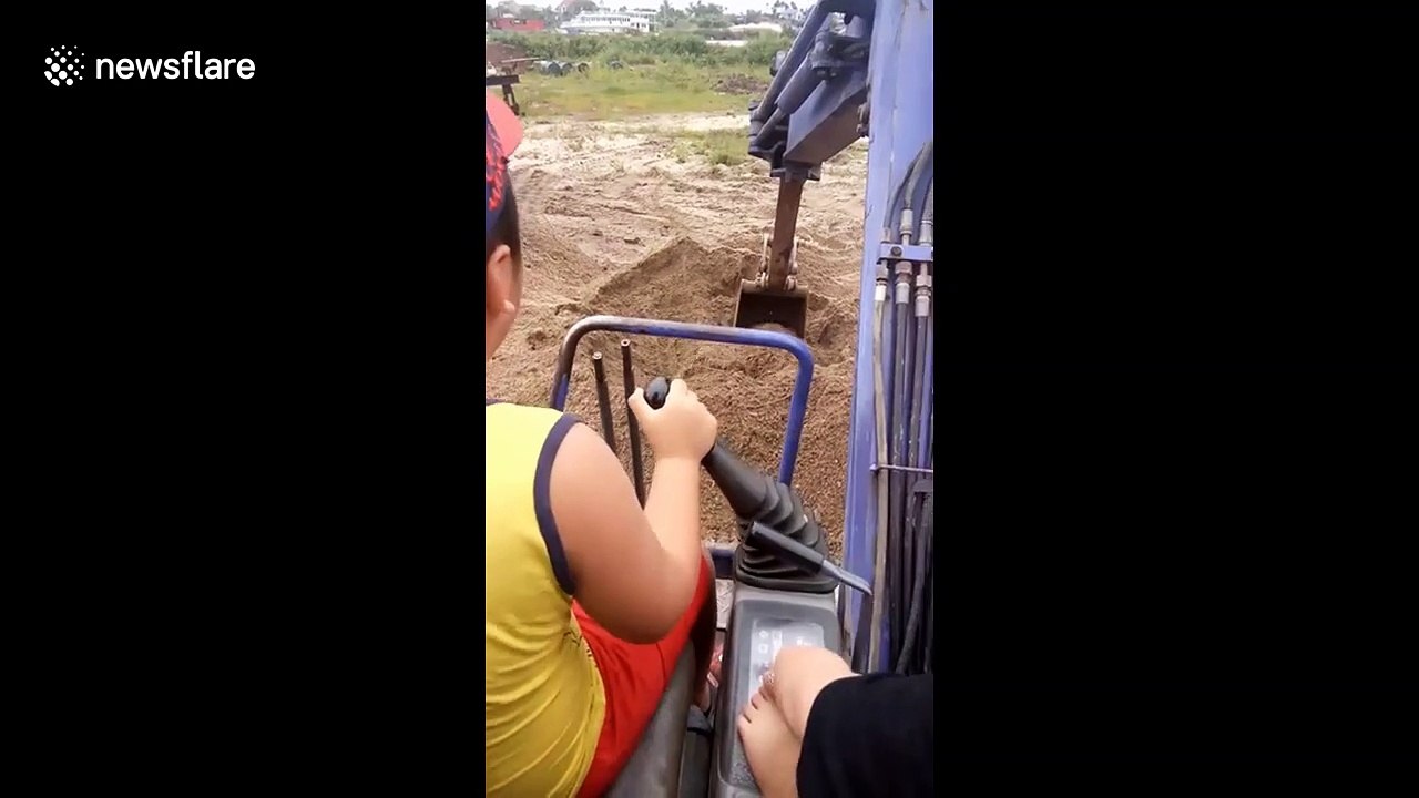 "Look what I got for Christmas!" Vietnamese six-year-old operates a real digger