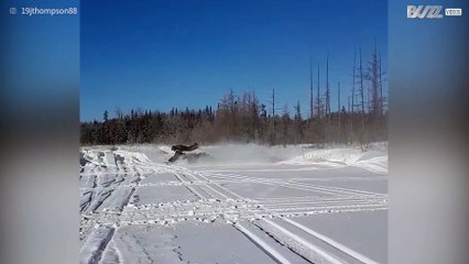 Snowmobile driver makes risky front flip while driving