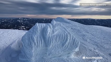Stunning footage shows building encased in snow
