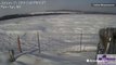 Heavy wind sends waves of snow rolling across field