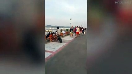 Tourists Carrying A Starfish In A Plastic Bag