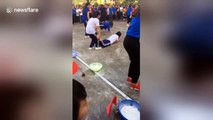 Girls in Vietnam engage in weird flour-eating wheelbarrow race