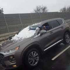 Woman Drives with Snow Completely Covering Windshield