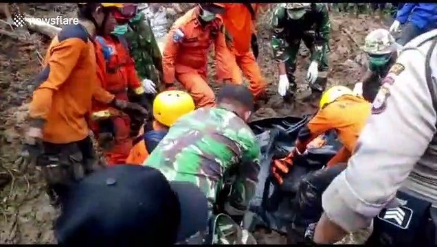 Search and rescue team evacuates landslide casualty in the wake of deadly Indonesia floods