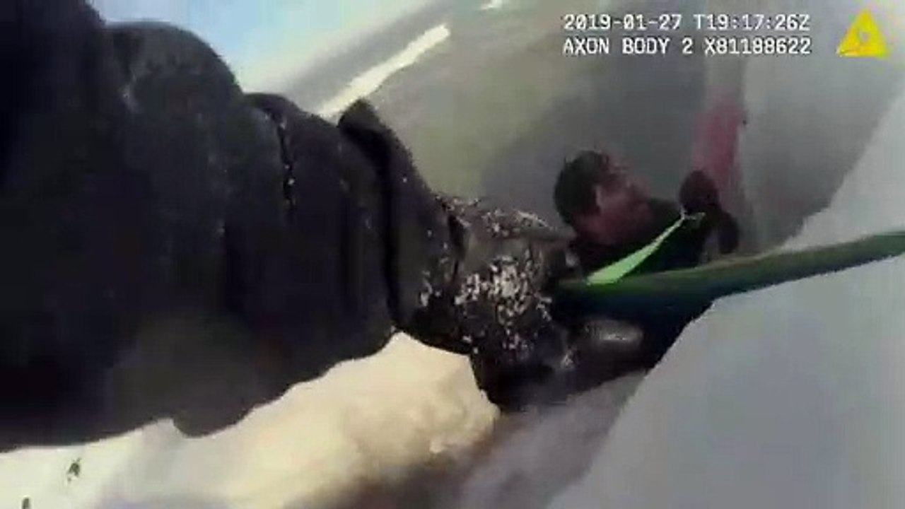 Dramatic footage shows man being rescued from i...