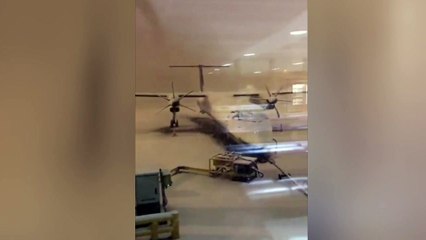 Stranded passenger films the scene from plane window at a snow-covered Manchester Airport