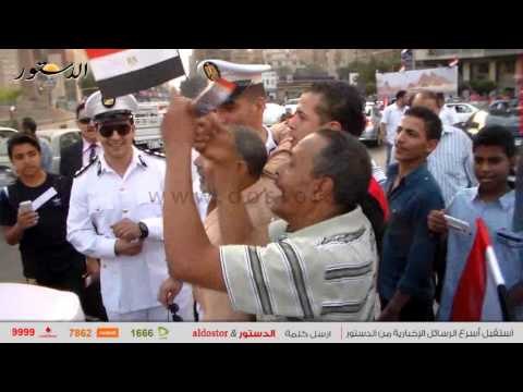 قسم الدقي يوزع الحلوى والأعلام احتفالًا بافتتاح قناة السويس