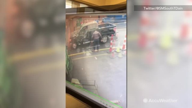 Guy slips on ice getting out of truck, spilling coffee