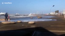 High tide surges onto boardwalk in Blackpool