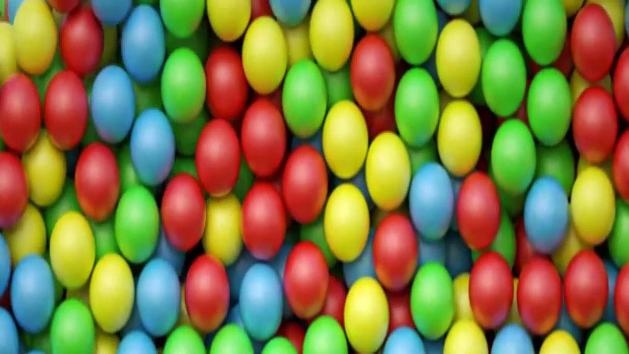 Multicolored candy, dragee on a plate, close-up. The plate rotates.