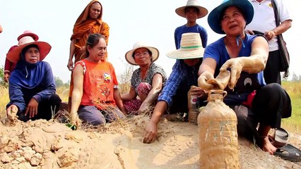 Superstitious villagers drink and bathe in mud they believe has special powers
