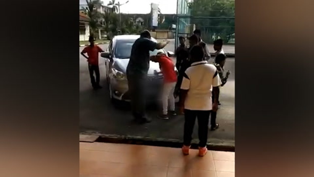 Cops identify man in video hitting boy for sticking chewing gum on car