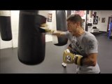 LUCIEN REID POUNDS THE HEAVY BAG IN CAMP WITH TRAINER PETER SIMS / iFL TV