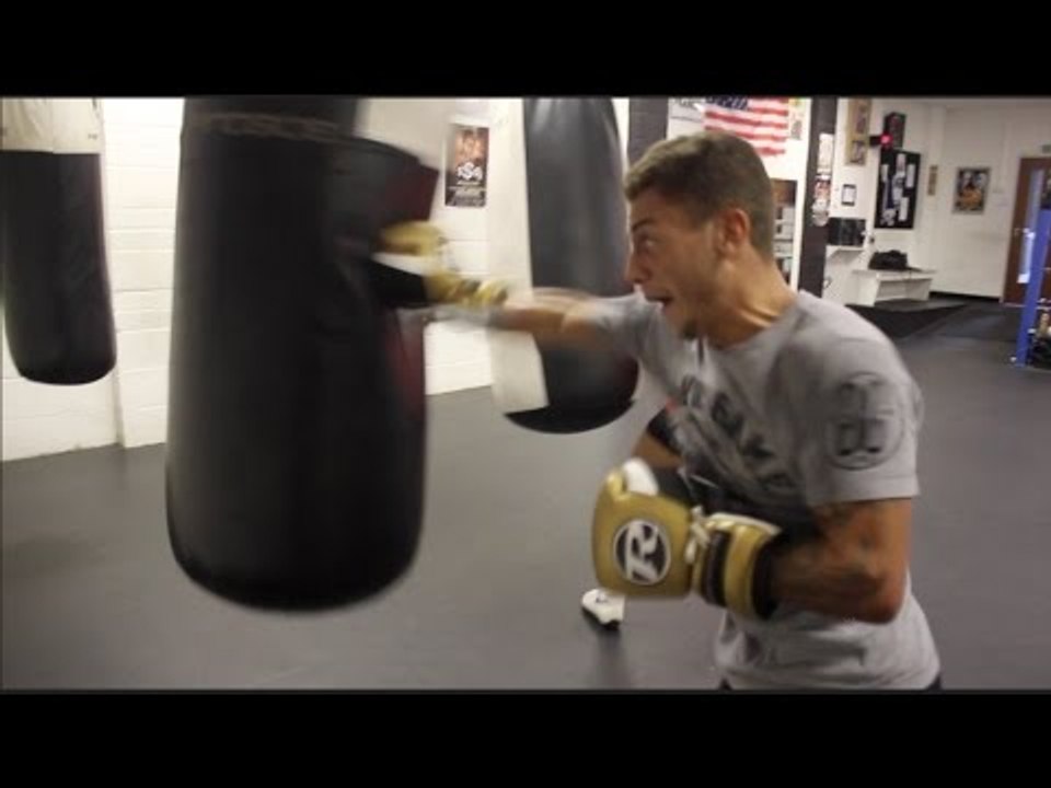 LUCIEN REID POUNDS THE HEAVY BAG IN CAMP WITH TRAINER PETER SIMS / iFL TV