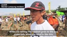 Hundreds sift through rubbish wasteland on Indonesia beach