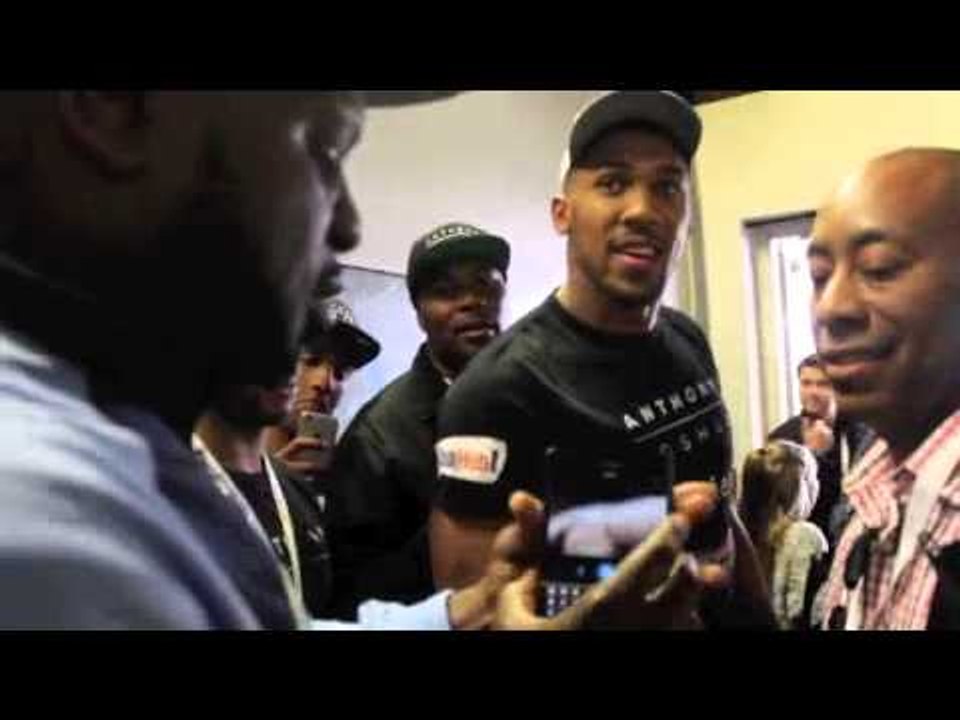 KEVIN JOHNSON BANTERS WITH ANTHONY JOSHUA IN THE CORRIDOR AS PAIR MEET AFTER WEIGH-IN .
