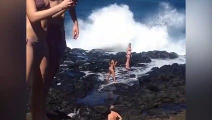 Deux filles se prennent en photo devant une grosse vague !