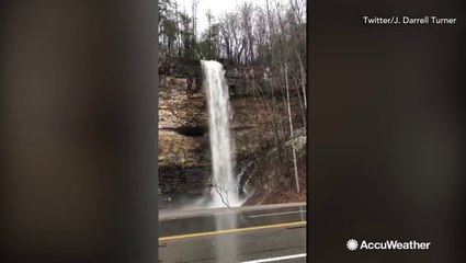 Theres so much flooding, this waterfall forms on side of highway