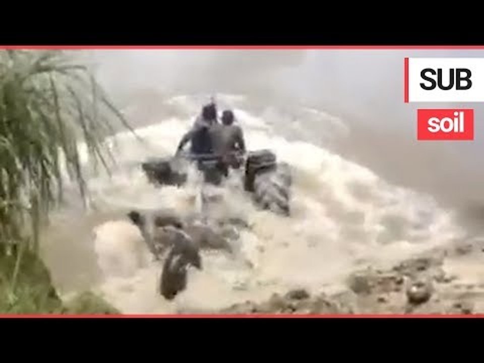 Farmers drive their tractor underwater "like a submarine" to cross between farms | SWNS TV