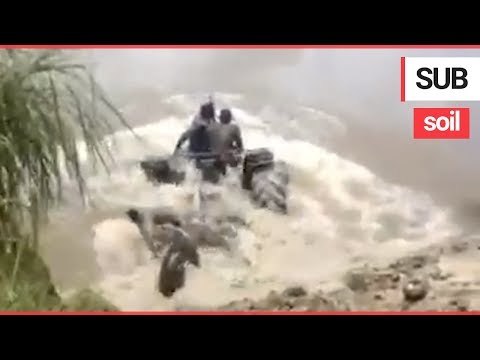 Farmers drive their tractor underwater like a submarine to cross between farms | SWNS TV