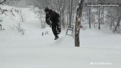 This man trudges through deep snow to do this...