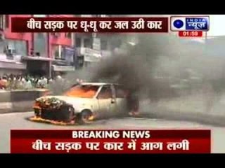 A car burns at Paharganj area of Delhi