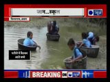 Assam: Kids cross river in aluminium pots to reach school |स्कूल के लिए पतीले में नदी पार करते बच्चे