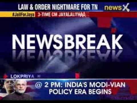 Angry protestors torch a government bus in Kariapatti