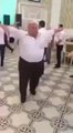 Fat man dancing funny at a wedding