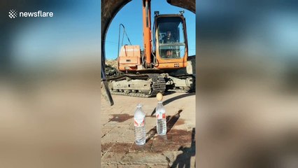 Smooth operator! Digger driver shows off his precision machinery control