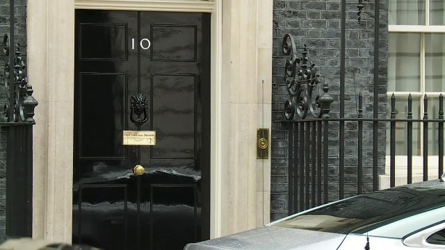 Theresa May leaves Downing Street for PMQs