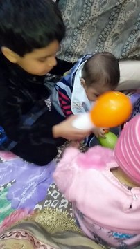 Kid Smiling and having fun with a baby