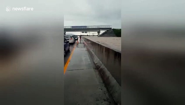 Indonesian floods sees one side of major East Java highway completely submerged