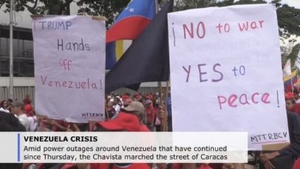 On a day of power outages, Maduro and Guaido followers march in Caracas
