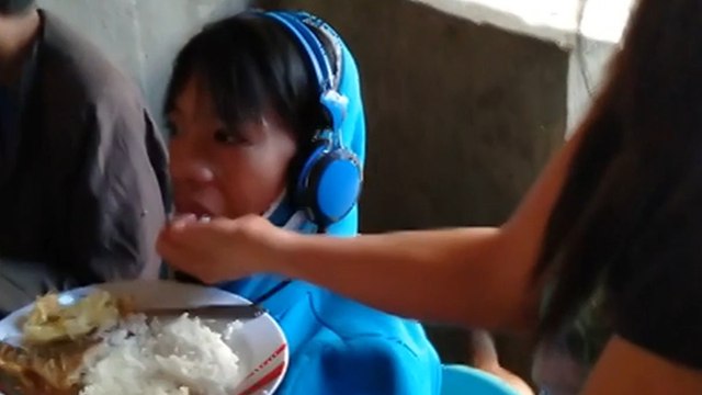 Desperate Filipino mother spoon-feeds game-addicted teenage son