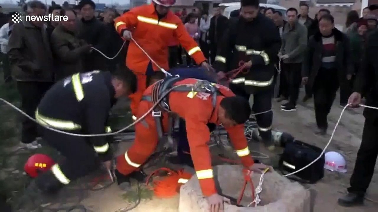 Fireman hangs upside-down to save old woman trapped in well in China’s Henan