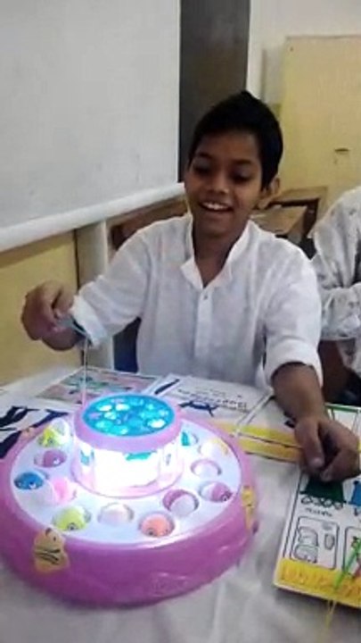 Child playing with fish toys