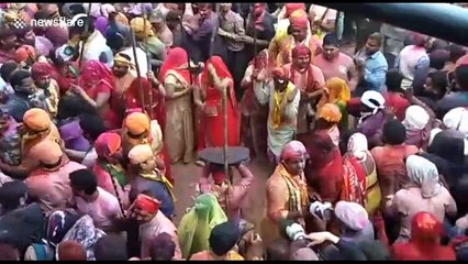 Women beat men with sticks during traditional north Indian festival