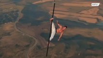 Russian daredevil performs bone-chilling stunts while suspended from hot air balloon