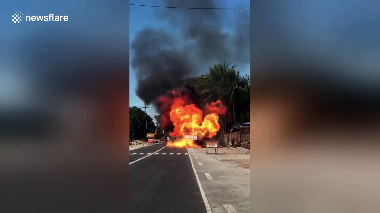Driver has to reverse to escape burning truck full of exploding butane tanks