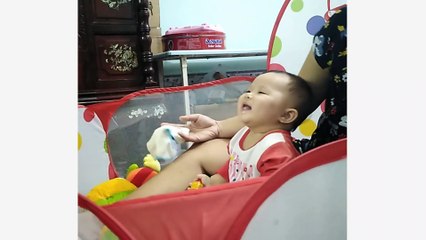The baby laughed and listened to the sound of the barking dog