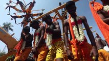Hindu devotees display their devotion by piercing skin with metal hooks and hanging from crane
