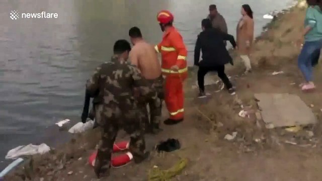 Firefighters save woman trapped in car that falls into lake in China's Hebei