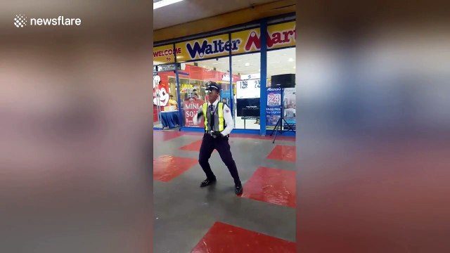 Security guard shows off dance moves outside supermarket