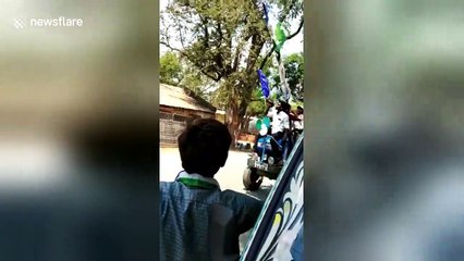 Men drink beer on tractor while canvasing for prohibition candidate in India
